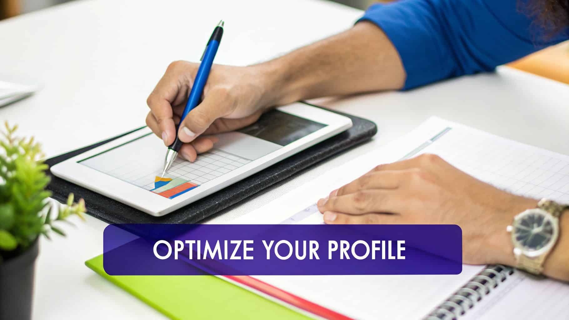 A person uses a stylus on a tablet displaying a chart, with a notebook and plant nearby.