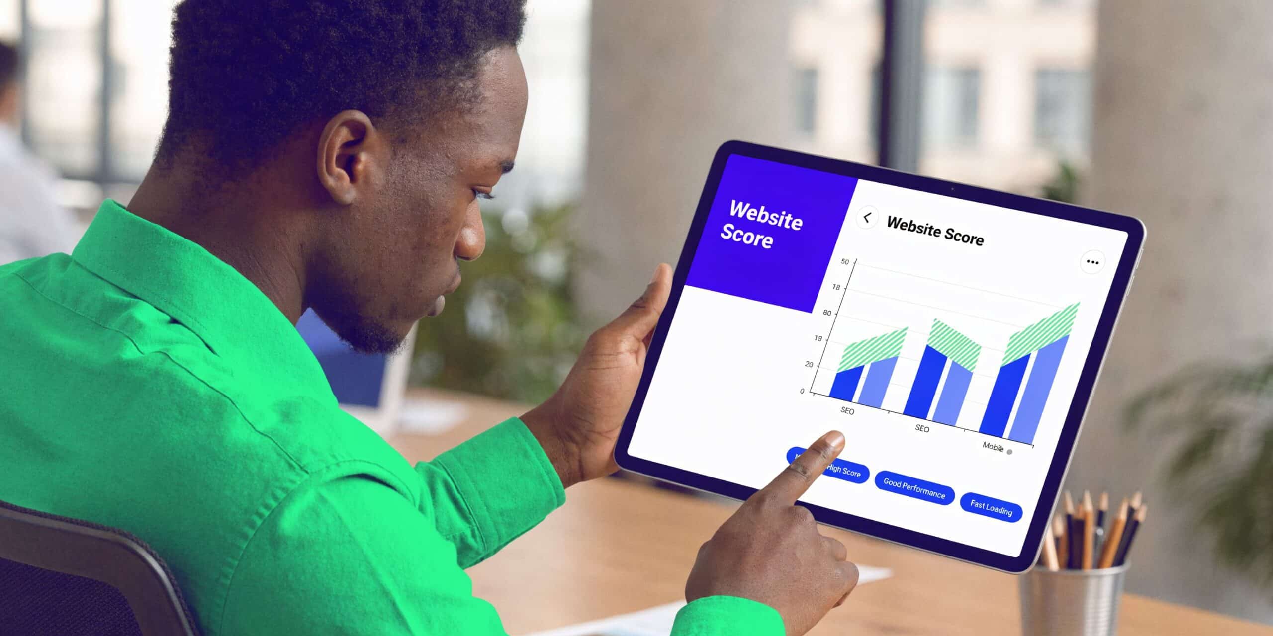 A professional man in a green shirt analyzing a website score dashboard on a digital tablet screen.