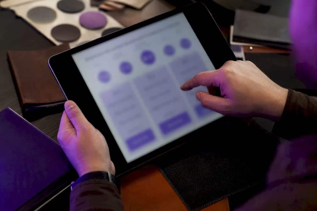 Hands using tablet showing promotional merchandise pricing tiers