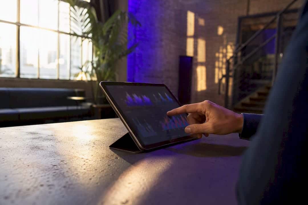 Hand interacting with HVAC bidding strategy tablet